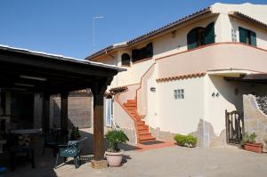a house with a patio in front of it at Comodo e ampio appartamento fronte mare in Loc. Maladroxia C535 in Maladroscia