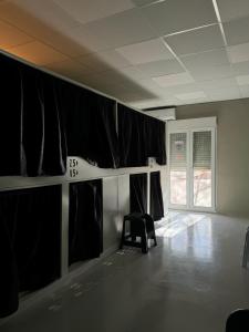 una habitación vacía con cortinas negras y una silla en NAP v, en Valencia