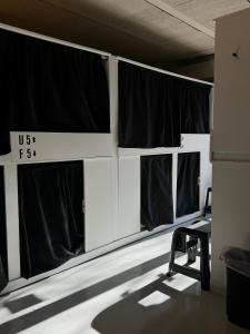 a room with black and white curtains and a chair at NAP v in Valencia