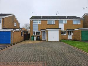a brick house with two garages and a driveway at 3 Severn close Contractor home in Oakham in Oakham