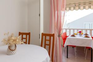 a dining room with two tables and a window at Apartments Vucica, Sevid in Sevid