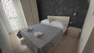 a bedroom with a bed with two towels on it at Apartments Vucica, Sevid in Sevid