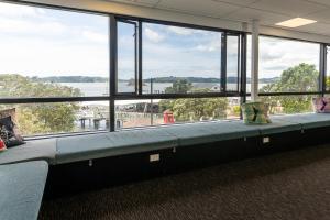 an empty room with a large window in an office at Haka Lodge Bay of Islands (Paihia) in Paihia