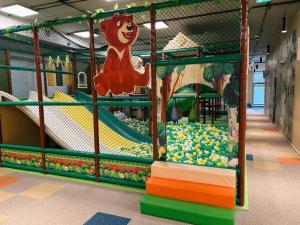 a play room with a roller coaster and a play yard at Aries Hotel & SPA Szczyrk in Szczyrk +86 photos