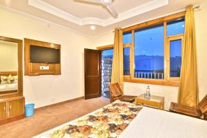 a bedroom with a bed and a large window at Hill Pine View in Dharamshala