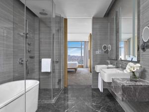 a bathroom with two sinks and a shower at Langham Place Guangzhou - Walking distance to Canton Fair in Guangzhou