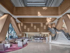 a rendering of a lobby with a spiral staircase at Langham Place Guangzhou - Walking distance to Canton Fair in Guangzhou