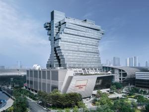 a tall building with a spiral in a city at Langham Place Guangzhou - Walking distance to Canton Fair in Guangzhou