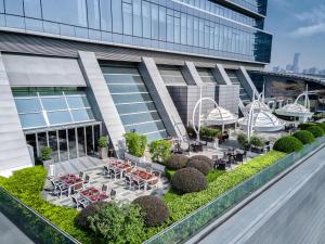 a view of a building with tables and chairs at Langham Place Guangzhou - Walking distance to Canton Fair in Guangzhou