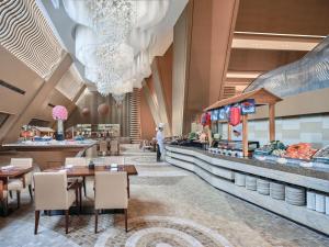 a rendering of a restaurant with tables and a buffet at Langham Place Guangzhou - Walking distance to Canton Fair in Guangzhou