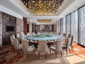 a conference room with a large table and chairs at Langham Place Guangzhou - Walking distance to Canton Fair in Guangzhou