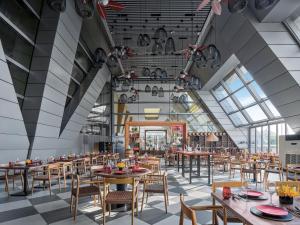 a rendering of a restaurant with tables and chairs at Langham Place Guangzhou - Walking distance to Canton Fair in Guangzhou