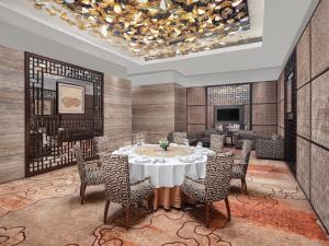 a dining room with a table and chairs at Langham Place Guangzhou - Walking distance to Canton Fair in Guangzhou