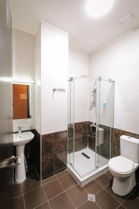 a bathroom with a shower and a toilet and a sink at Hotel Darchi in Tbilisi City