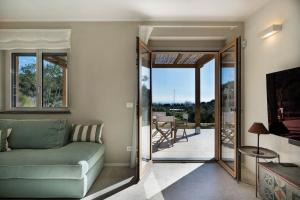 a living room with a couch and a sliding glass door at Borgo Isasco in Finale Ligure