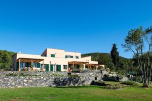 a house on top of a stone wall at Borgo Isasco in Finale Ligure