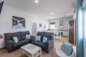 a living room with a couch and a table at Casa Rural Lola - Lantejuela in La Lantejuela