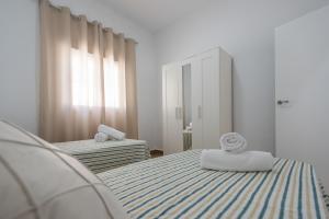 a bedroom with two beds with towels on them at Casa Rural Lola - Lantejuela in La Lantejuela +39 photos