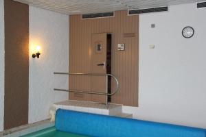 a hallway with a staircase and a door in a building at Villa Relax - Ferienwohnungen & Hallenbad & Relaxgarten in Bodenmais