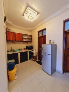 a kitchen with a refrigerator in the middle of it at Home Stay Boutique Zanzibar in Stone Town