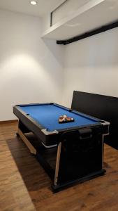 uma mesa de pingue-pongue num quarto com em Cottonwood 4BR Villa Sutami with Pool Netflix BBQ em Bandung