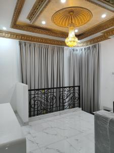 a room with a curtain and a chandelier at 2 bedroom, 1 kitchen in Jakarta