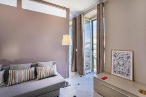 a living room with a couch and a large window at City and the Sea by Wonderful Italy in Genoa