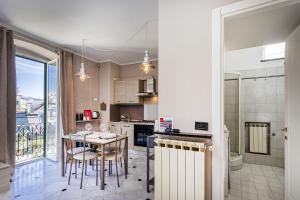 a kitchen and dining room with a table and chairs at City and the Sea by Wonderful Italy in Genoa