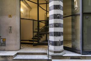 an empty building with a column and stairs in it at City and the Sea by Wonderful Italy in Genoa
