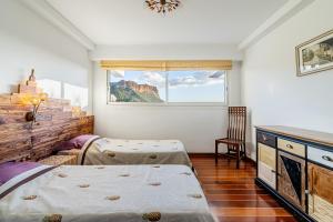 a bedroom with two beds and a window at Les Restanques par Dodo à Cassis in Cassis +26 photos