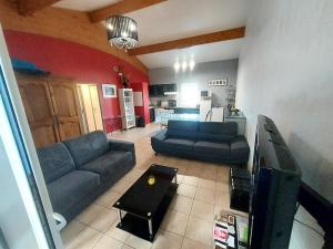 a living room with two couches and a tv at Appart*Résidence piscine*Parking*3mn Centre Sarlat in Sarlat-la-Canéda