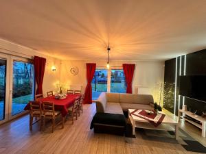 a living room with a couch and a table at Domowy Zakątek in Tuchom