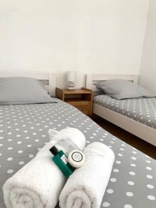a bedroom with two beds with towels on the bed at T3 Terrasse près de la plage in Nice