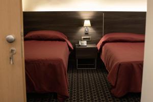 Posteľ alebo postele v izbe v ubytovaní Gemelli Hotel
