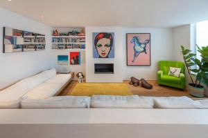 a living room with a white couch and a green chair at Chic 2-bedroom home - Richmond upon Thames in London