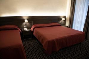 Posteľ alebo postele v izbe v ubytovaní Gemelli Hotel