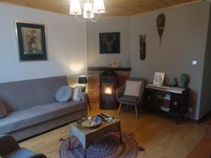 a living room with a couch and a table at Casa da Porta de Santo António in Bragança