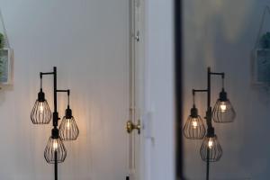 a group of lights on a wall next to a door at Open Mind Property - Southsea with Free Parking in Portsmouth