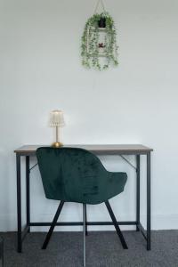 a desk with a green chair and a lamp at Open Mind Property - Southsea with Free Parking in Portsmouth