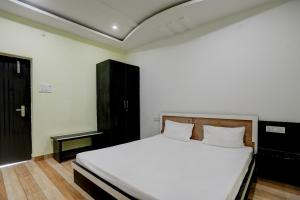 A bed or beds in a room at OYO The Nirvana Resorts