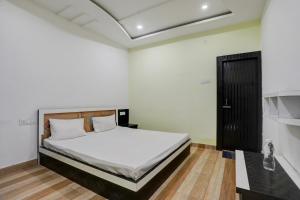 A bed or beds in a room at OYO The Nirvana Resorts