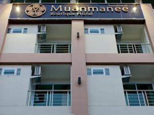 a building with a sign on the side of it at Muanmanee Boutique Hotel in Loei