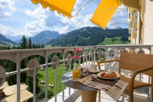 a table with a plate of food on a balcony at Gstaad Palace in Gstaad