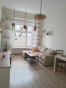 a living room with a couch and a table at Night Host Trzebnicka 84/1B in Wrocław