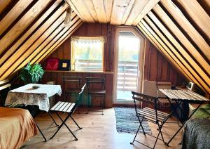 a room with a bed and a table in a attic at Lili puhkemaja Kuutsemäel in Otepää +52 photos