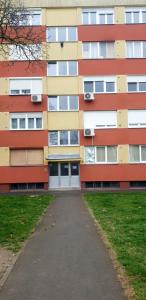 an apartment building with a sidewalk in front of it at Apartman Klara in Osijek