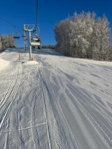 un remonte en una pista de esquí cubierta de nieve en Lili puhkemaja Kuutsemäel, 