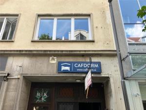 a building with a sign on the front of it at CafDorm in Maribor