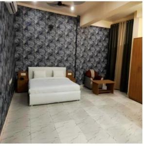 a living room with a white couch and a chair at The Purezza in Greater Noida