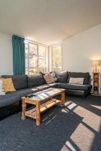 a living room with a couch and a coffee table at Haka Lodge Queenstown in Queenstown